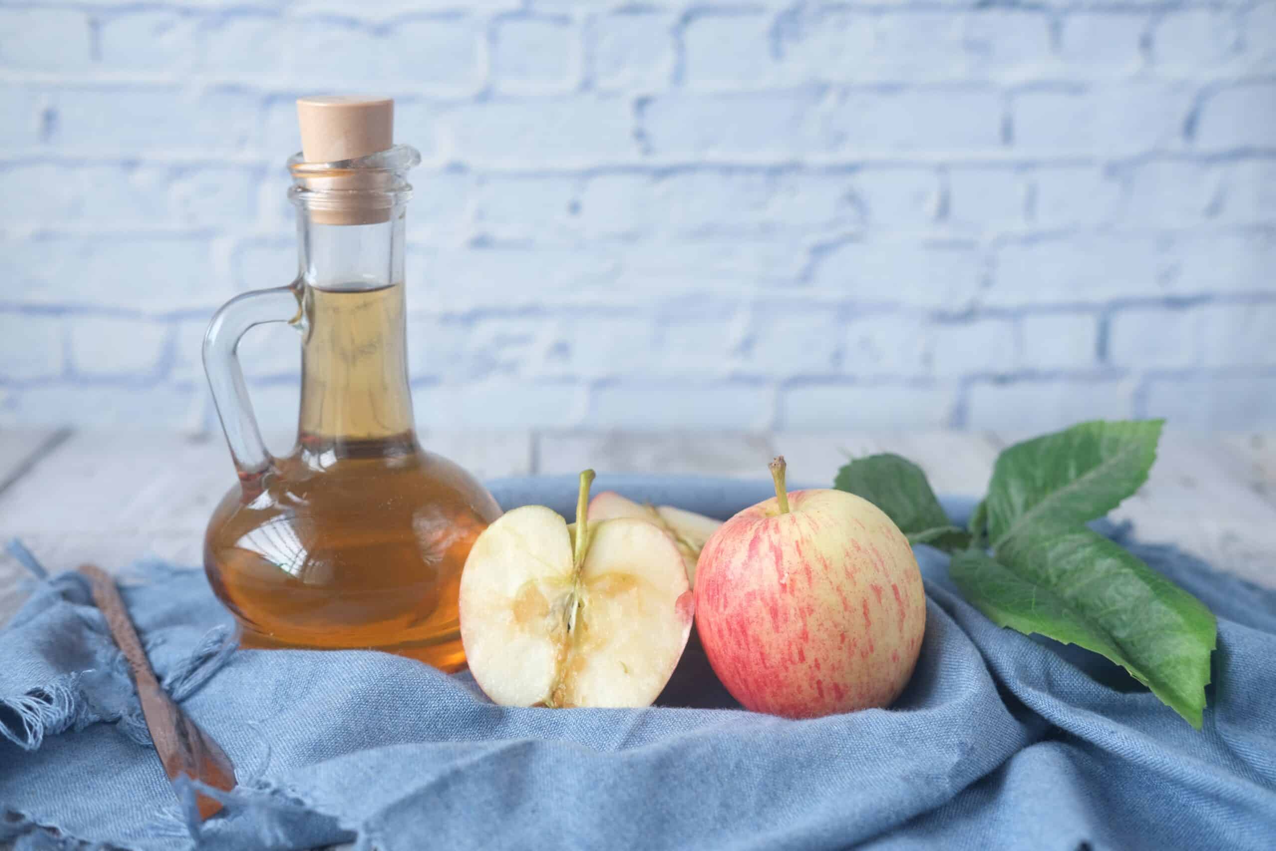 Healthy Apple Cider Vinegar for Weight Loss and Some Apples on a Cloth. WeightLoss-Solutions Teaches Clean Eating with Things Like Vinegar to Change Your Life Through Diet and Exercise.
